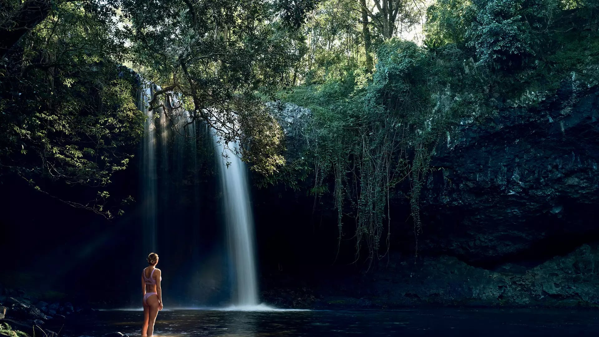 woman in front of waterfall in Newrybar Byron Bay  Sydney Bespoke Tours