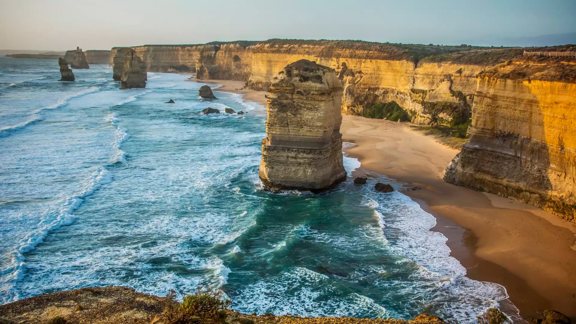 Scenic view of limestone rock stacks in the ocean along a high cliff coastline.