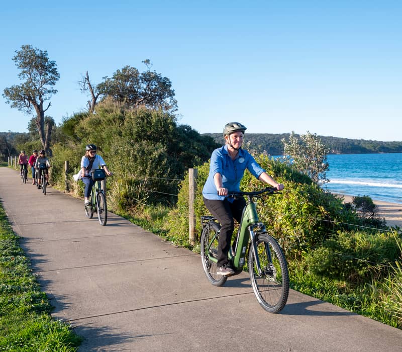 A group of cyclists on an e-bike tour with Navigate Expeditions along the Pambula coastline.