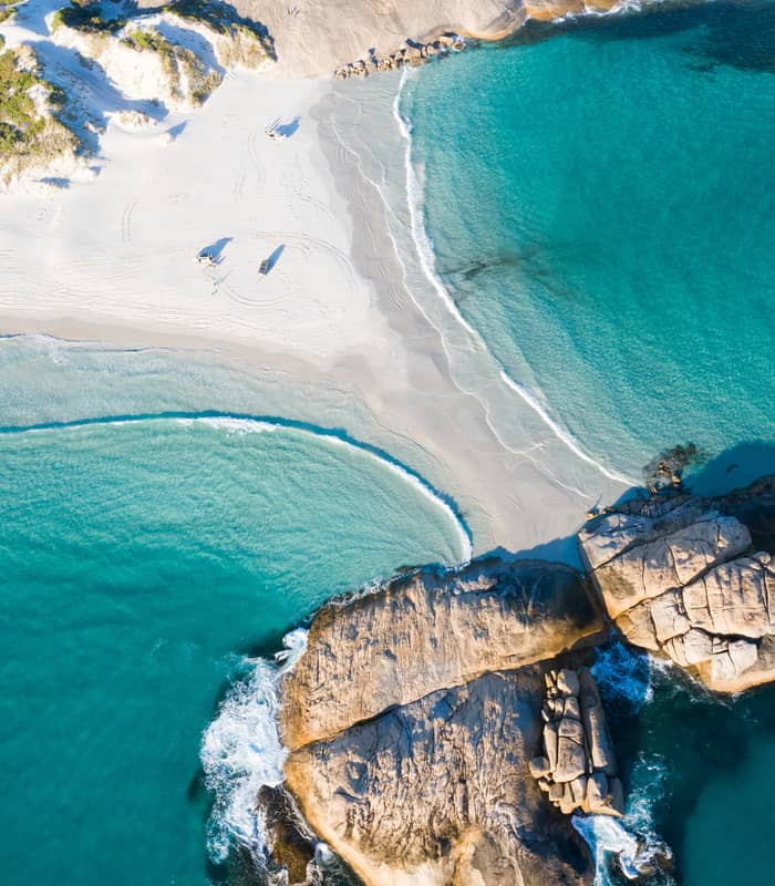 Crystal clear turquoise water laps against the famously white silica sands of Wylie Bay in Esperance - Bay of Isles.