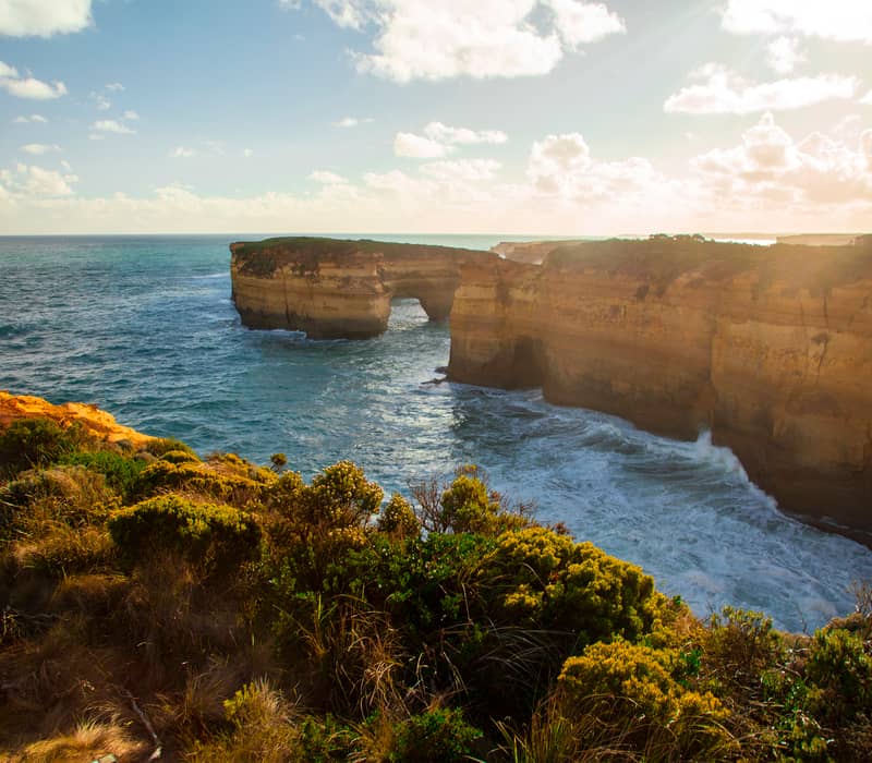 Coastal view of the Twelve Apostles limestone formations and steep cliffs along the Great Ocean Road in Victoria.
