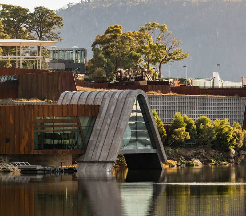 Modern architectural structure of Pharos at Mona museum over the water at sunset.
