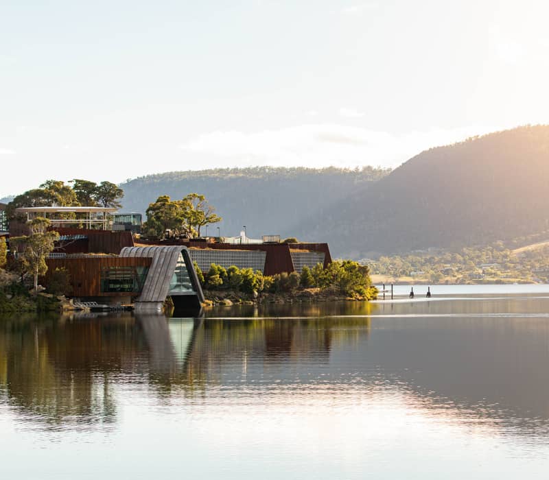 Daytime view of the Mona museum buildings and waterfront in Hobart.