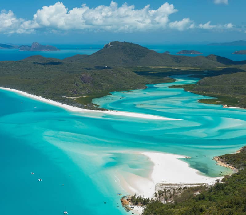 High-angle view of the swirling blue water and white sand of Hill Inlet in the Whitsundays.