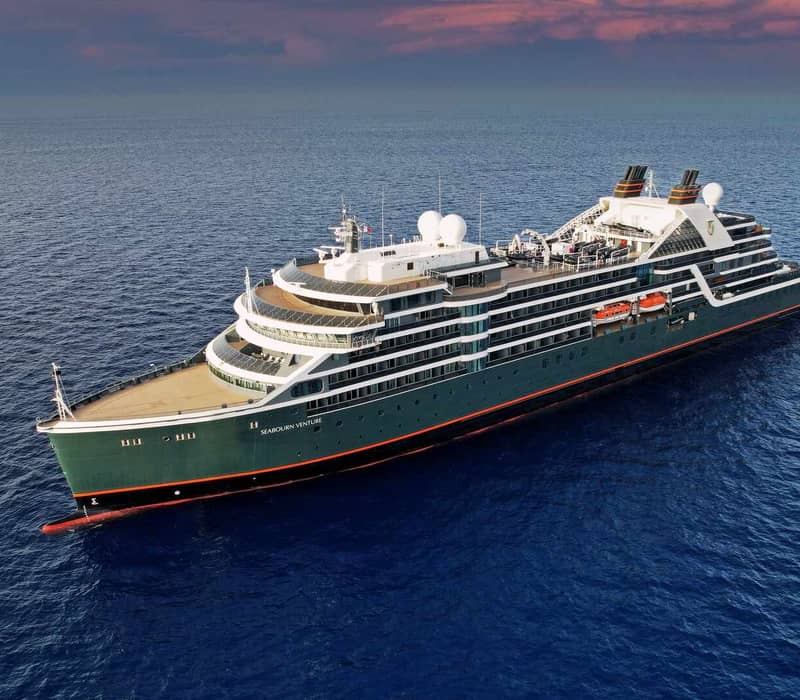 A stunning aerial shot of the Seabourn Pursuit, the newest ultra-luxury addition to APT’s Kimberley fleet, highlighting its sleek design against the rugged Australian coastline.