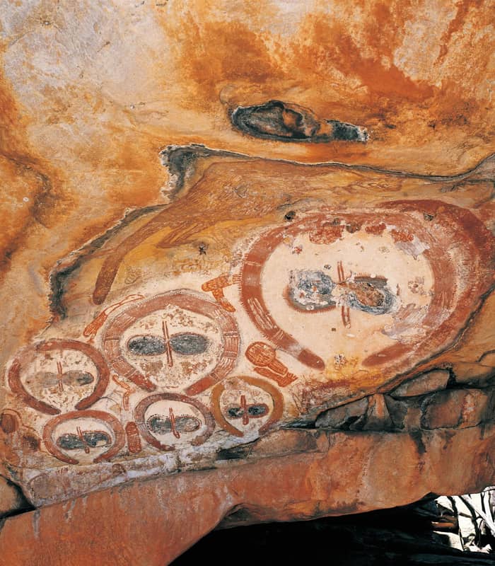 Wandjina rock art with vivid patterns in Kimberley's rugged stone.