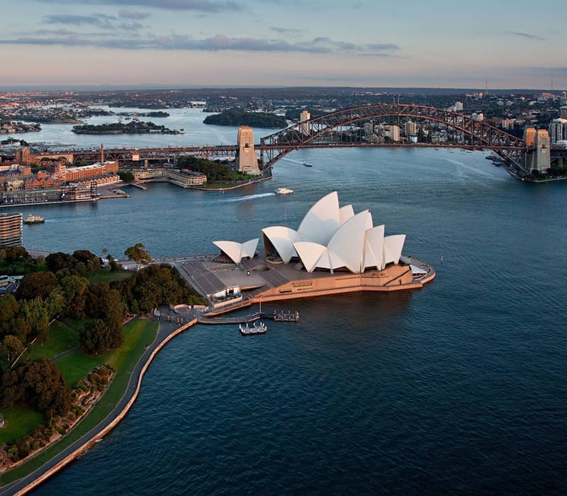 Aerial view of Sydney Harbour with Opera House and Harbour Bridge.