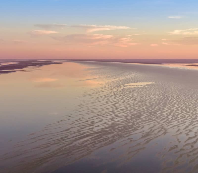 A spectacular aerial view of Kati Thanda–Lake Eyre in the Flinders Ranges and Outback, capturing the surreal patterns of floodwaters and salt crusts during a rare filling event.