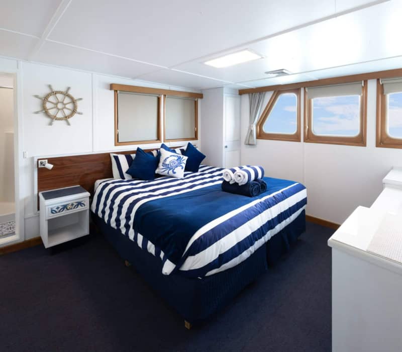 The primary expedition vessel for Eco Abrolhos Cruise sailing through the rugged coastal landscapes of Western Australia.