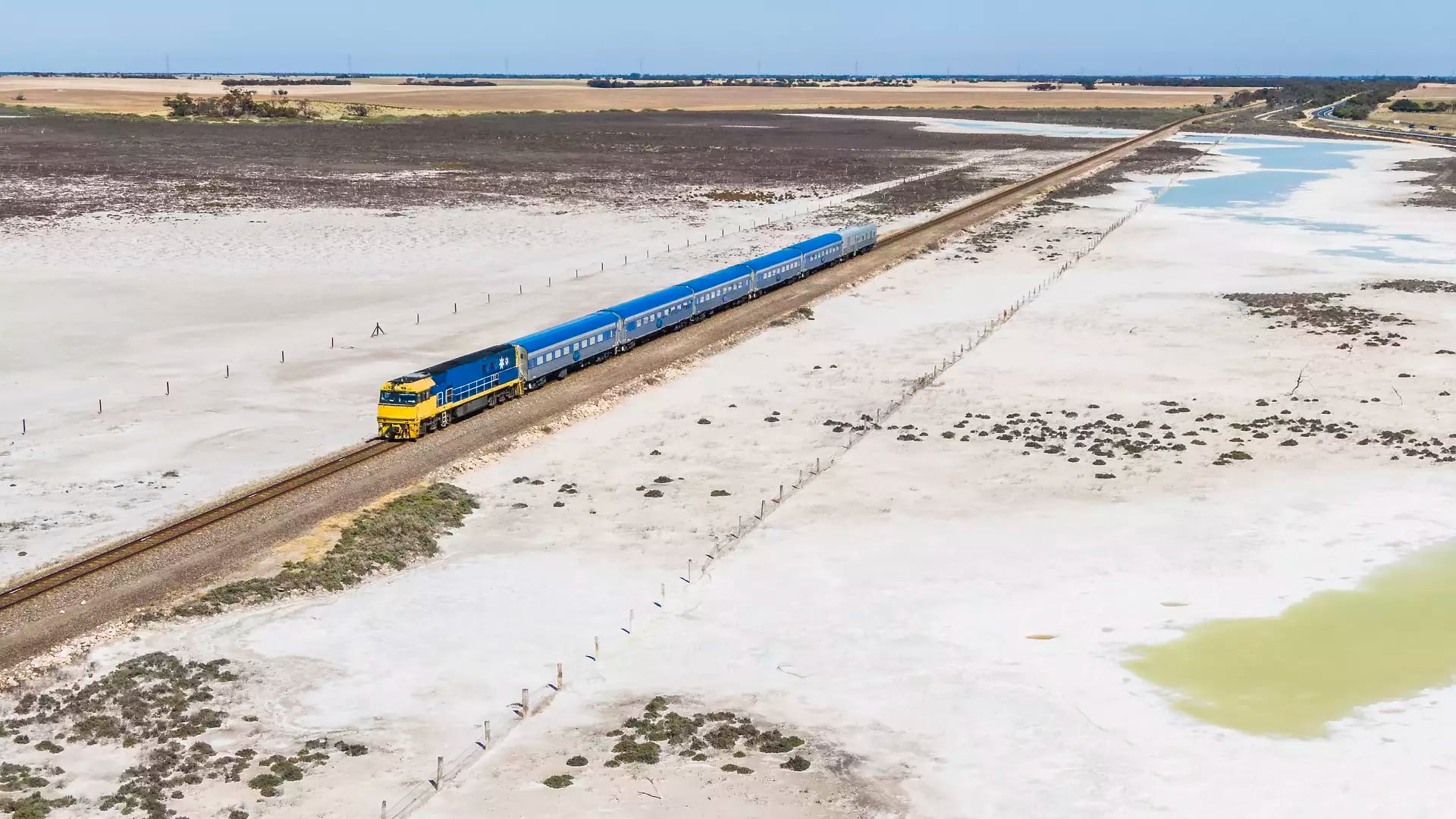 Aerial shot of The Overland Train over salt plains. 