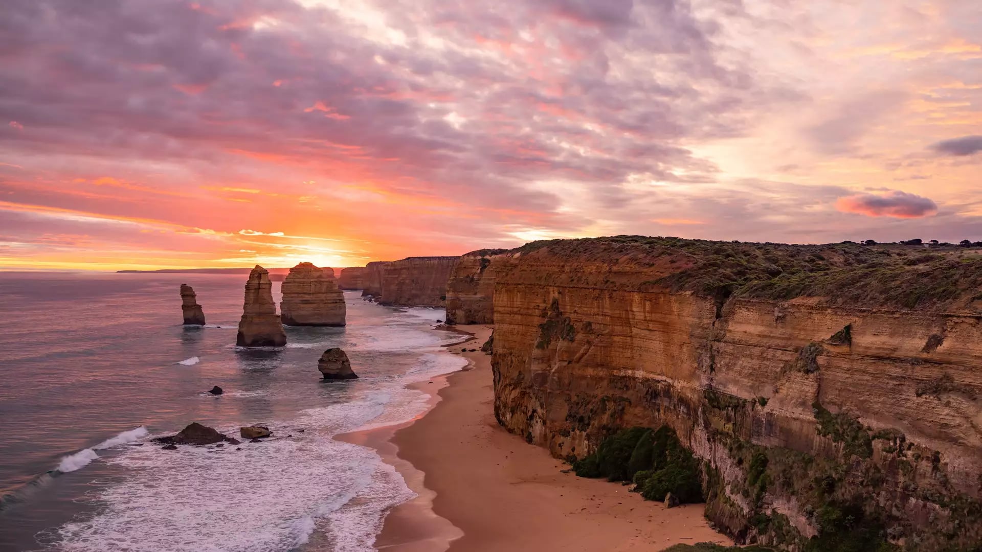Iconic limestone rock formations of the Twelve Apostles at sunset along the Victorian coastline.