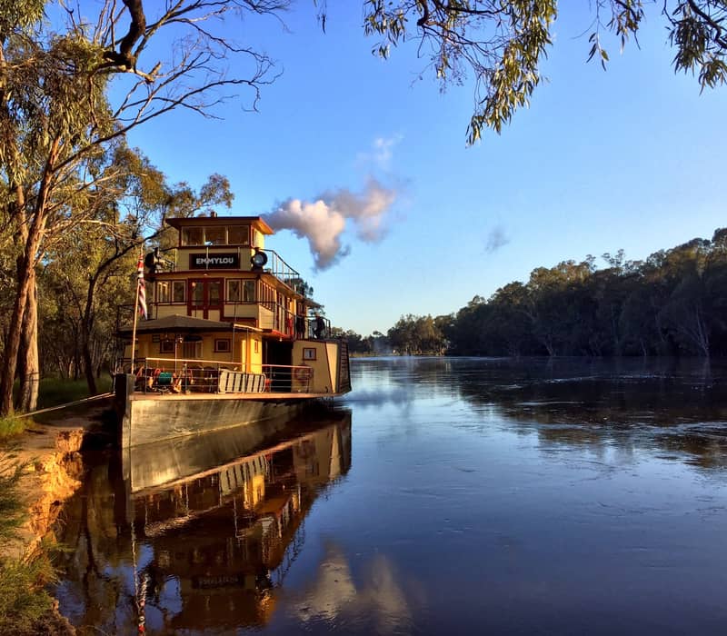 A peaceful golden hour reflection of the paddlesteamer PS Emmylou in the calm waters of the Murray River.