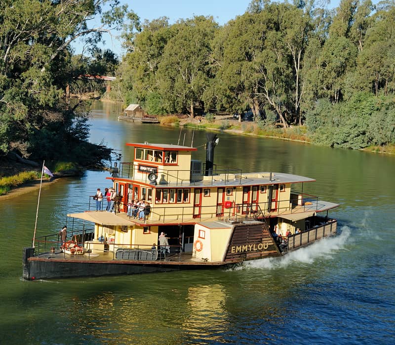 The historic paddlesteamer PS Emmylou with passengers on deck cruising on the Murray River near Echuca, Victoria.