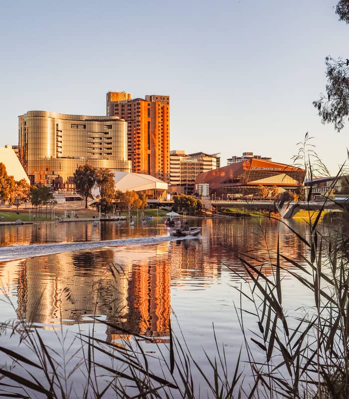 Scenic view of the Adelaide Riverbank and Convention Centre reflected in the River Torrens at sunset.