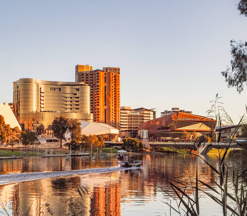 Scenic view of the Adelaide Riverbank and Convention Centre reflected in the River Torrens at sunset.