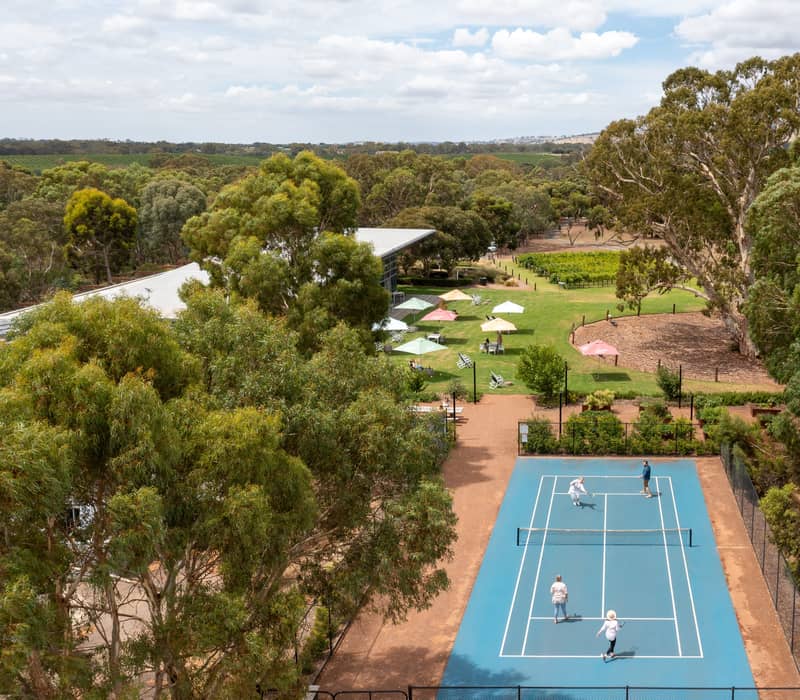 Aerial view of a tennis match played on the grounds of Jacob's Creek vineyards.