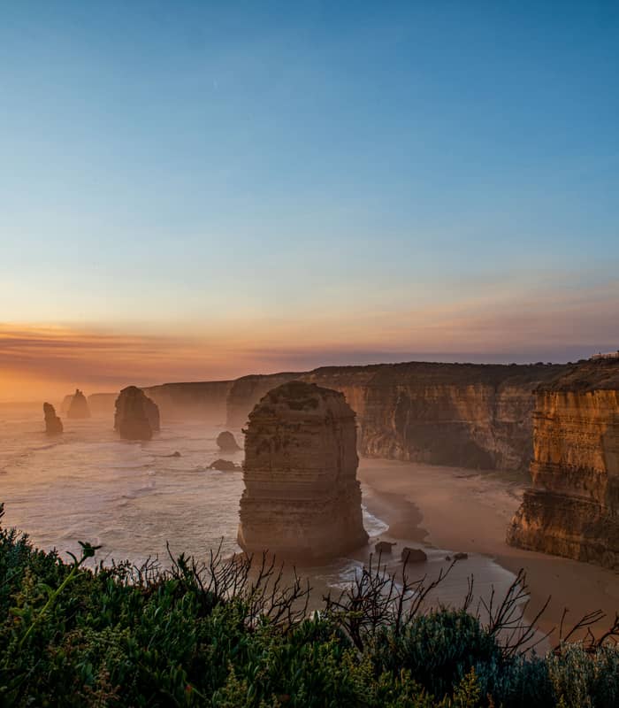 Sunset view of the Twelve Apostles limestone stacks on the Great Ocean Road in Victoria, Australia.